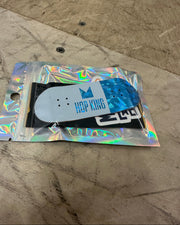 Skateboard deck with colorful packaging on a concrete surface