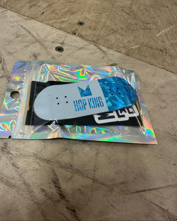 Skateboard deck with colorful packaging on a concrete surface