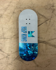 Skateboard deck with 'Hop King' logo on a textured surface